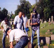 Members of SUV Dennison Camp #1 resetting stones and cleaning gravesites at Greenlawn Cemetery, Columbus Ohio.