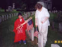 Family assisting with flagging of veteran's graves on Memorial Day, 2000.